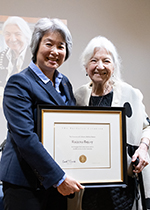 Dean Liu presents the Berkeley Citation, a framed certificate signed by Chancellor Christ, to Ruzena Bajcsy.